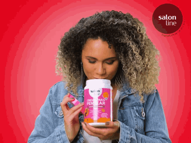 a woman is holding a container of salon line creme para pentear