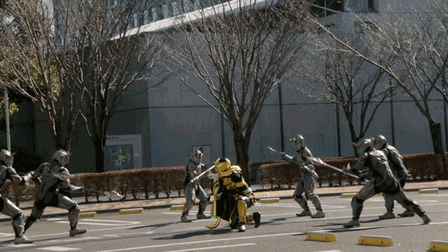 a group of people in armor are standing on the street