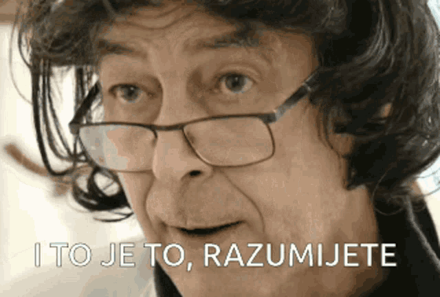 a man wearing glasses is making a funny face with the words i to je to razumjete written below him .