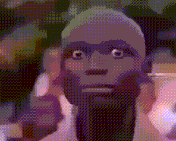 a close up of a man 's face with a beard and big eyes