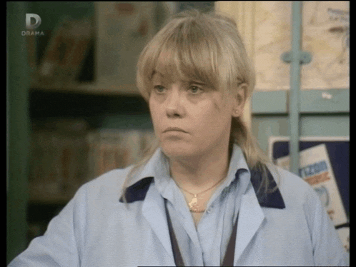 a woman wearing a blue shirt and a necklace is on a tv screen that says drama