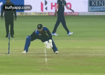 a cricket game is being played on a field sponsored by kent cement