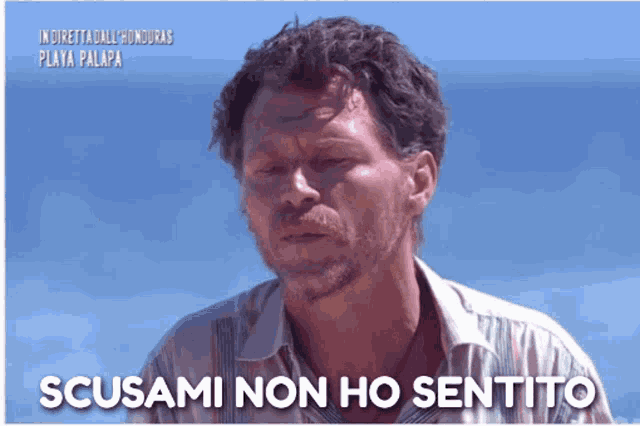 a man with the words scusami non ho sentito on the bottom