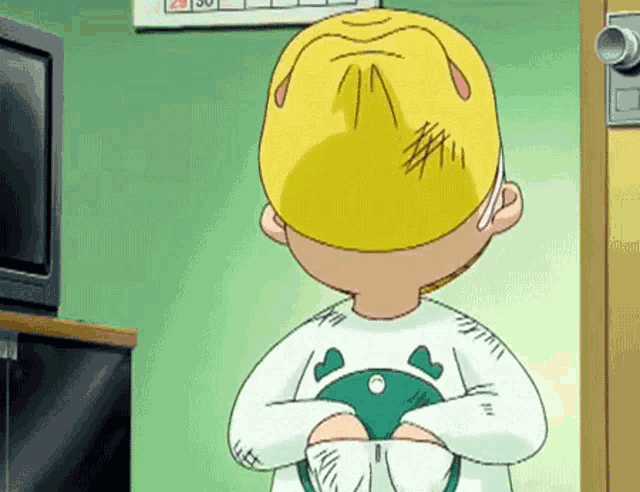 a cartoon character with a yellow hat on his head stands in front of a television