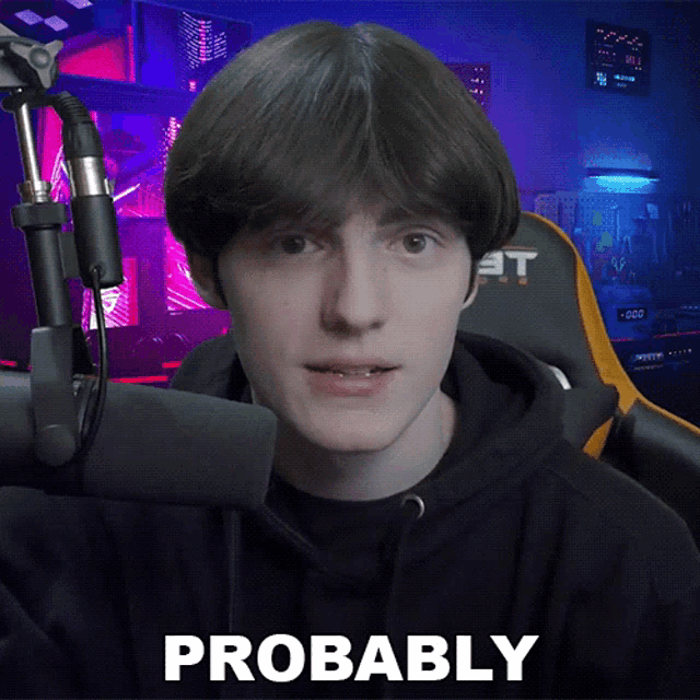 a young man in front of a microphone with probably written on the bottom