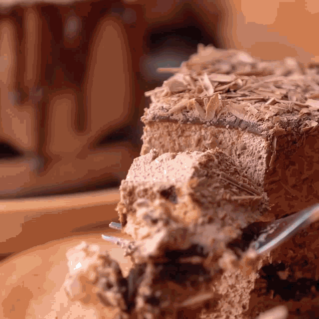 a close up of a piece of chocolate cake with a fork in it