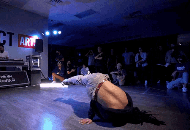 a man is doing a handstand in front of a sign that says ct art