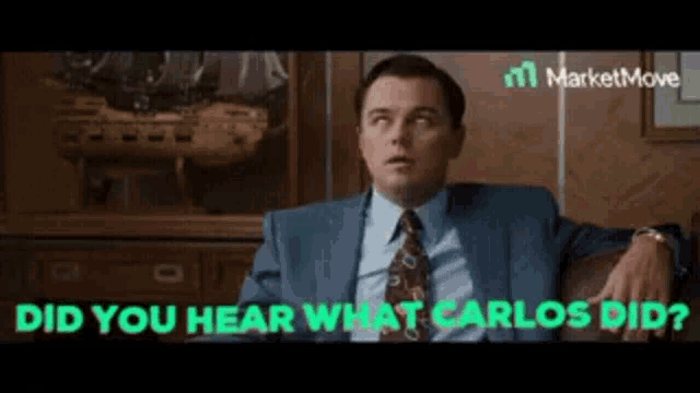 a man in a suit and tie is sitting on a couch with the words " did you hear what carlos did ? "