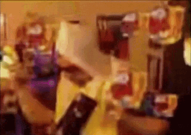 a blurry picture of a man holding a bottle of beer in a dark room