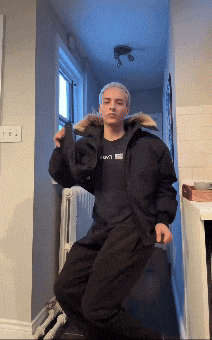 a man wearing a black jacket and a black shirt that says levi 's on it