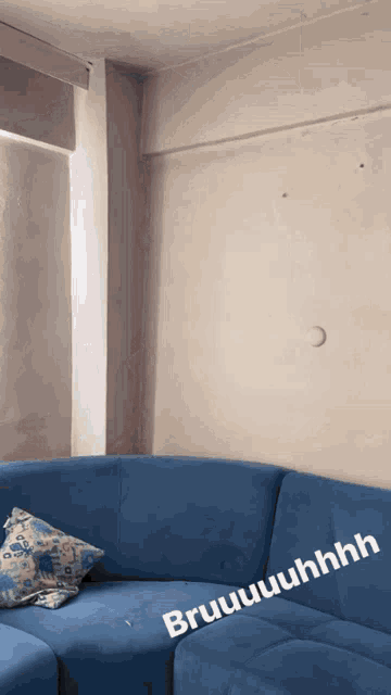 a blue couch in a living room with the words bruuuuuuuhhhh written on the bottom
