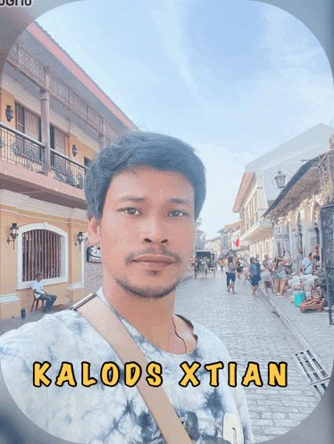 a man named kalods xtian is standing in front of a building