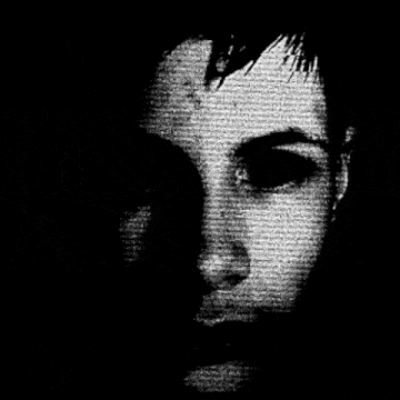 a close up of a person 's face with red eyes in a black and white photo .