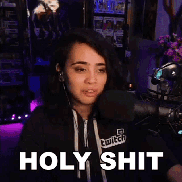 a woman wearing a hoodie that says twitch on it says holy shit