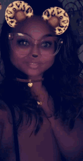 a woman wearing glasses and a choker with a heart pendant