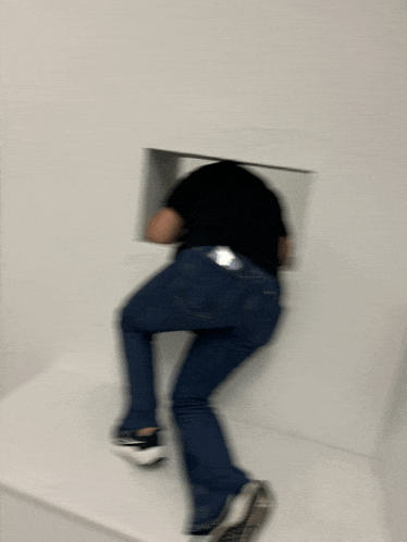 a blurry picture of a person standing in front of a wall