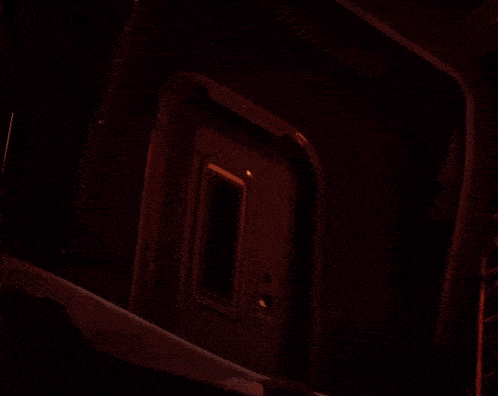 a pumpkin with a face carved into it is sitting in the dark