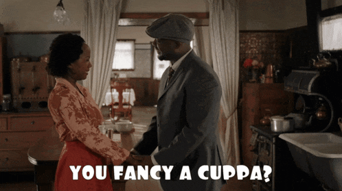 a man and a woman are holding hands in a kitchen with the caption " you fancy a cuppa "
