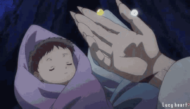 a baby wrapped in a purple blanket is being held by someone 's hand