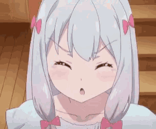 a girl with white hair and a pink bow in her hair is making a face and saying show me .
