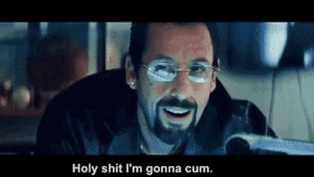 a man with glasses and a beard is smiling and saying holy shit i 'm gonna cum