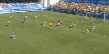 a group of soccer players are running on a field in front of an advertisement for sport tv