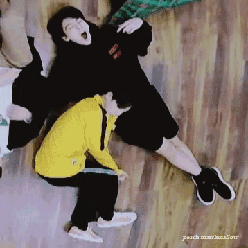 a group of people laying on a wooden floor with peach marshmallow written on the bottom right corner