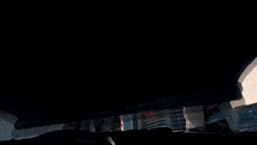 a man and woman are looking under the hood of a car