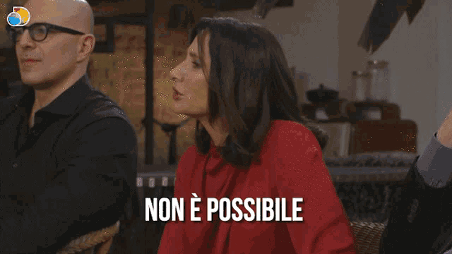 a woman in a red shirt says non e possibile in white letters