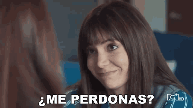a woman is smiling while talking to another woman and the words `` me perdonas '' are written on the screen .