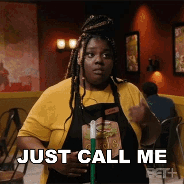 a woman in an apron is holding a mop and says just call me
