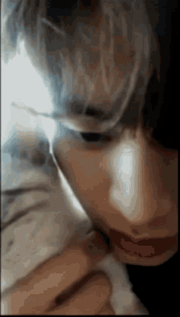 a close up of a person smoking a cigarette
