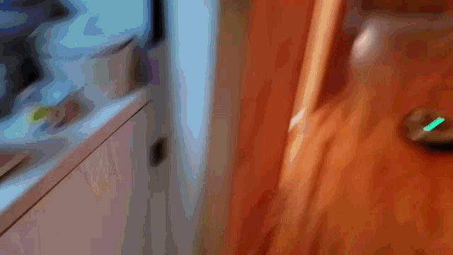 a robotic vacuum cleaner is moving down a hallway in a house