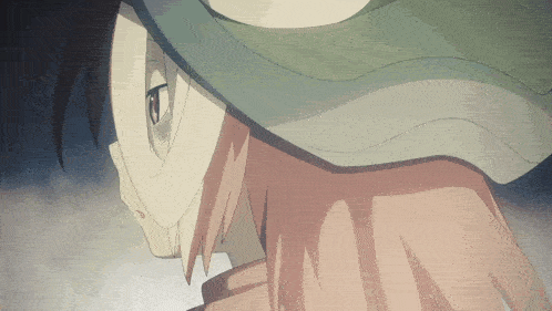 a close up of a person 's face with a green hat on