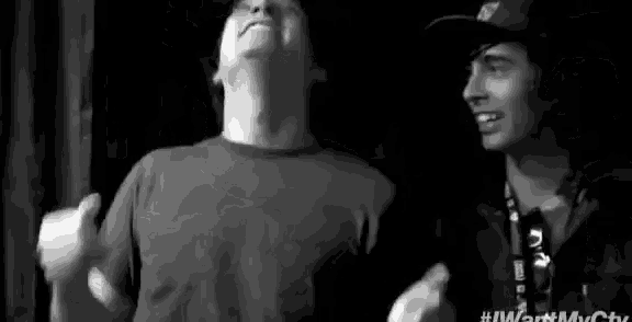 two men are dancing in a black and white photo .