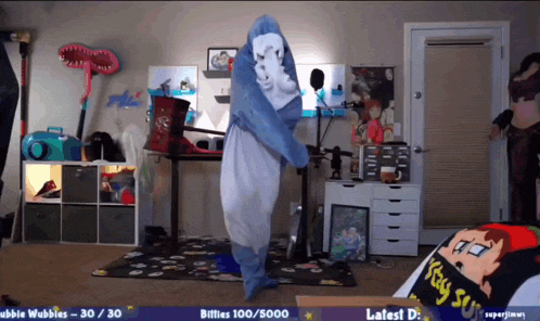 a person in a shark costume is dancing in a room with a purple banner that says " bitties 100/5000 "