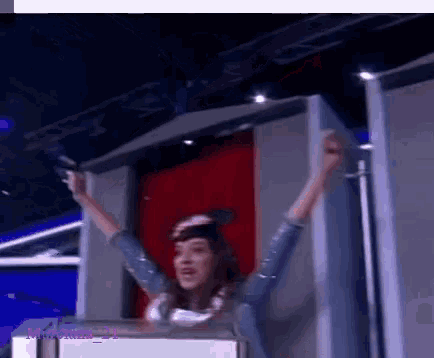 a woman with her arms in the air behind a sign that says murciano_21