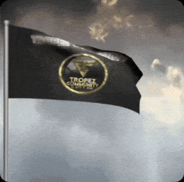 a black flag that says tropez community is flying in the wind