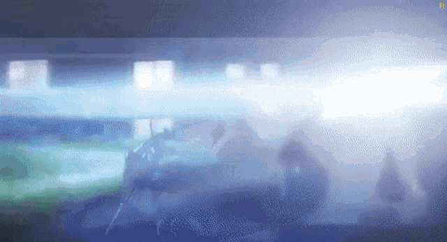 a group of people are standing in a dark room with smoke coming out of the ceiling .