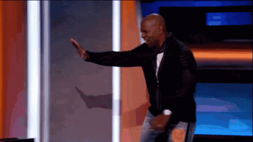 a man in a black jacket and jeans is dancing on a stage