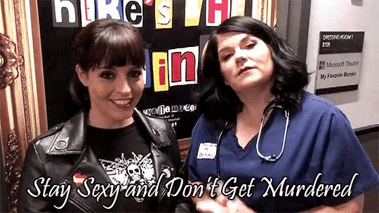 two women standing in front of a sign that says hire 's the brain