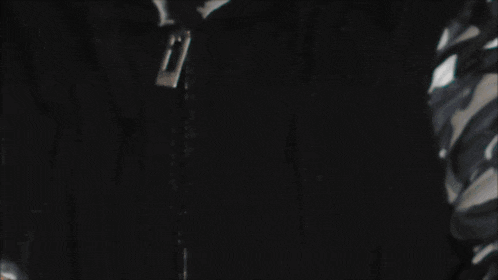 a man wearing a black jacket with a zipper