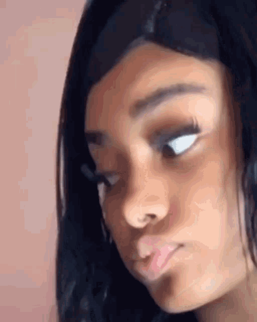 a close up of a woman 's face making a face .