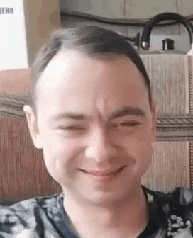 a close up of a man 's face with his eyes closed .