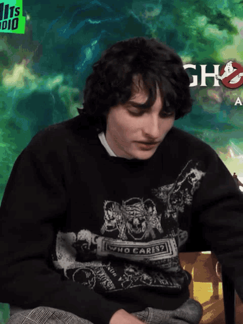 a man wearing a sweater that says who cares