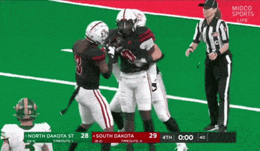 a football game between north dakota and south dakota is underway