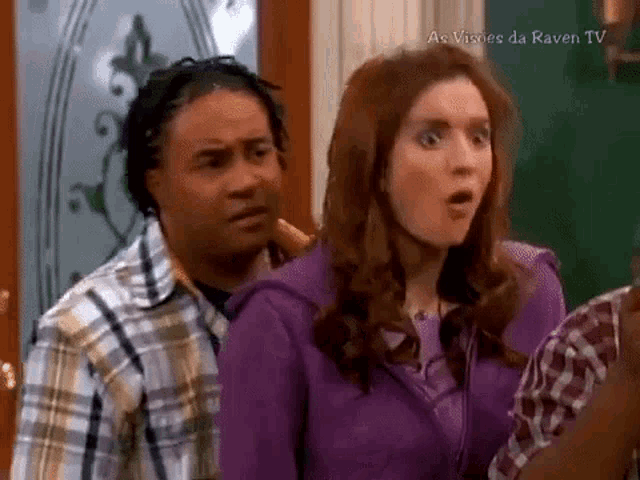 a man and a woman are standing next to each other in a room .