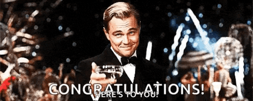a man in a tuxedo is holding a champagne flute and says congratulations