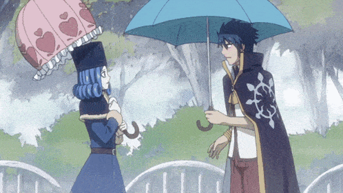 a man holding a blue umbrella stands next to a woman with a pink umbrella on her head