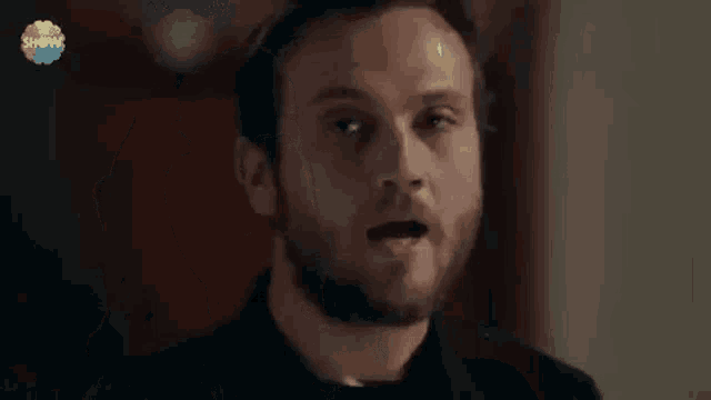 a close up of a man 's face with the word show on the bottom left